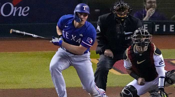 Rangers shortstop Corey Seager hits a single against the Diamondbacks during Game 5 of the 2023 World Series